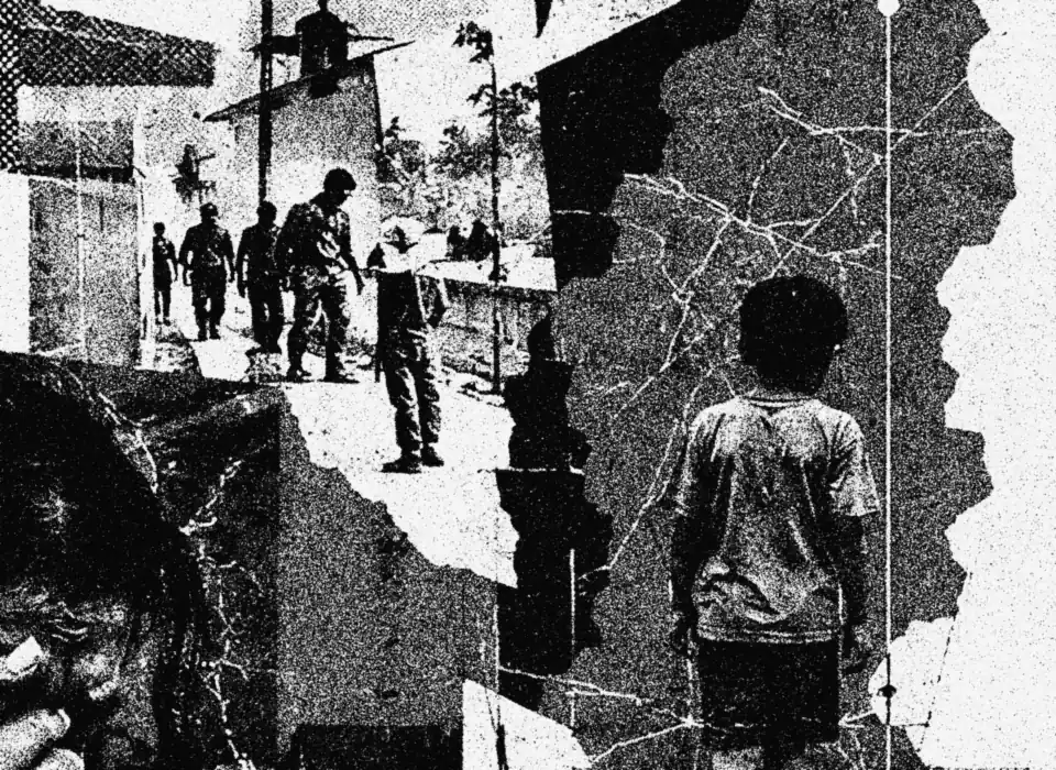 Armed men on a road and a boy standing on a cracked map