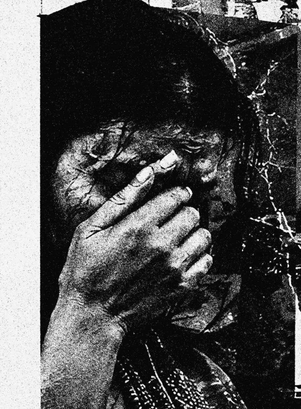 A woman weeping, covering her face