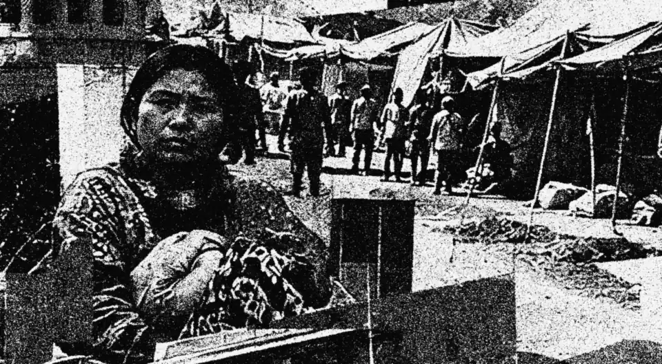 A woman in a crowded relief camp