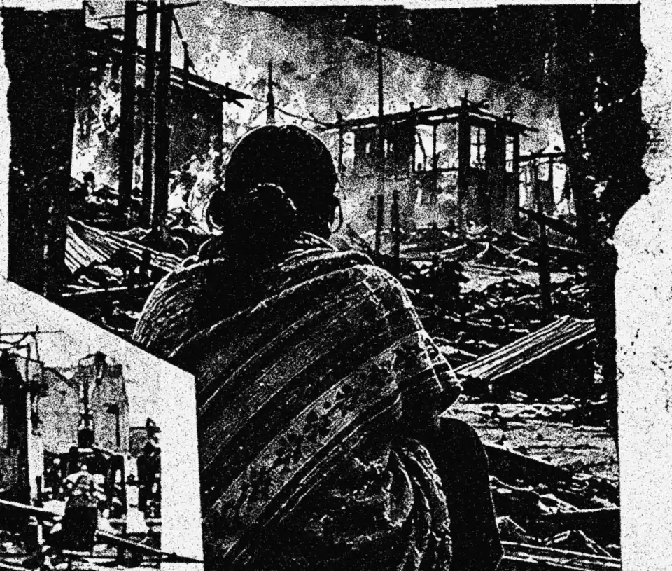 A woman watching homes burn