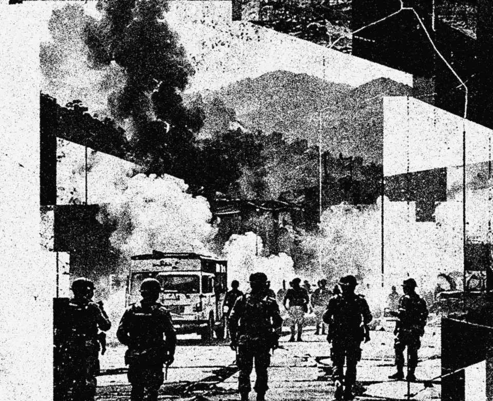 Security forces advancing through tear-gas smoke