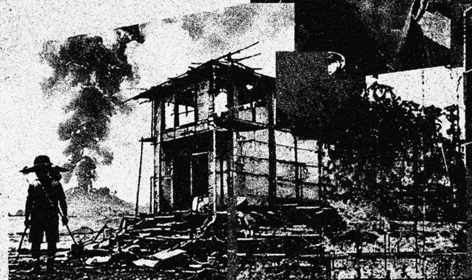 A gutted house and a lone figure on a hillside